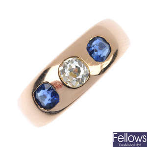 An early 20th century gold diamond and sapphire three-stone band ring.