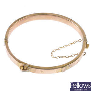 A late Victorian 9ct gold buckle motif hinged bangle.