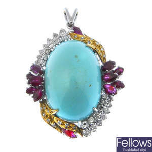 A reconstituted turquoise, ruby and diamond pendant. 