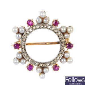 An early 20th century diamond, ruby and seed pearl wreath brooch.