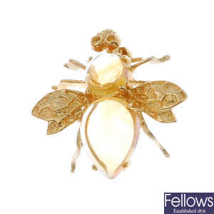 A citrine bee brooch.