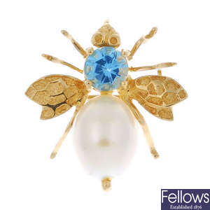 A cultured pearl and topaz bee brooch.