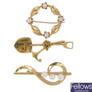 A selection of three gold brooches.