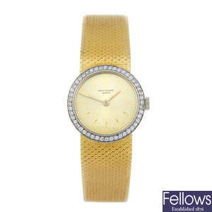 PATEK PHILIPPE - a lady's yellow metal bracelet watch.
