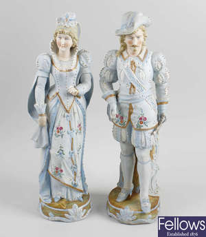  A pair of late 19th century tinted bisque porcelain figures. 