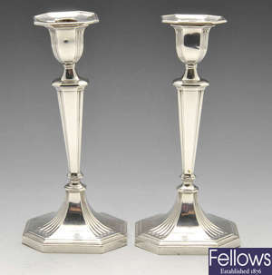 A pair of Edwardian silver candlesticks with loaded bases.
