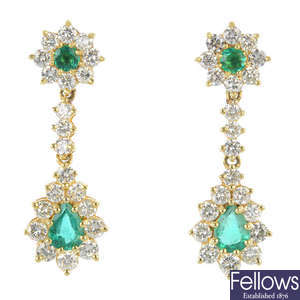 A pair of emerald and diamond cluster ear pendants.