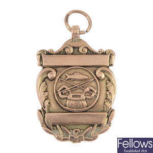 An early 20th century 9ct gold fishing medallion.