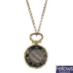 A late 19th century enamel memorial locket and 9ct gold chain.