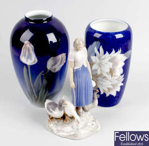 A Bing & Grondahl figure, plus two Royal Copenhagen porcelain vases.