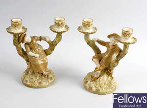 A pair of James Hadley Royal Worcester candlesticks, plus four figures. 