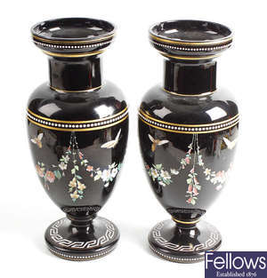 A pair of late 19th century enamelled black glass vases.