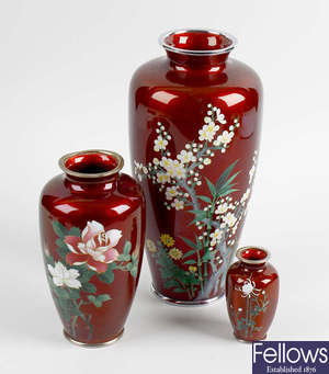 A small group of red-ground cloisonne vases. 