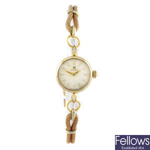 OMEGA - a lady's gold plated wrist watch.