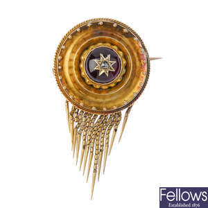 A late 19th century gold garnet and diamond brooch.