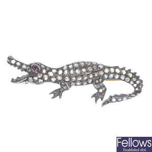 An early 20th century silver and gold ruby and diamond alligator brooch.