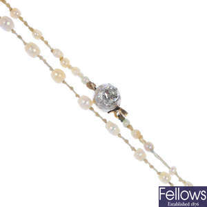 A pearl necklace with diamond clasp.