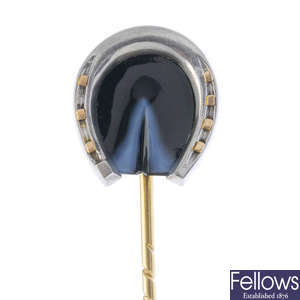 An early 20th century platinum and gold, onyx horseshoe stickpin.