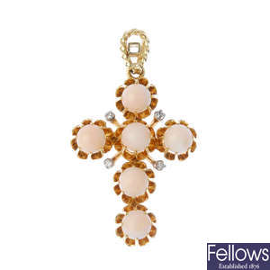 A coral and diamond cross pendant.