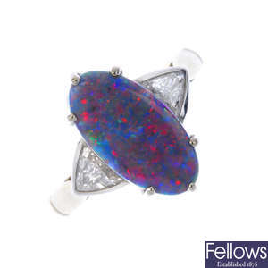 An 18ct gold opal doublet and diamond three-stone ring.