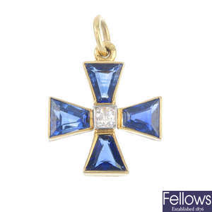 A diamond and sapphire cross pendant.