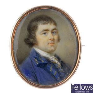 An early 19th century gold painted portrait brooch.