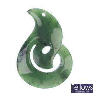 A carved Maori jade koru pendant.