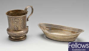 A George IV christening mug, Edwardian dish & a claret jug mount. (3).