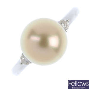 A cultured pearl and diamond three-stone ring.