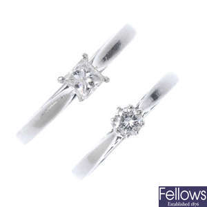 Two platinum diamond single-stone rings.