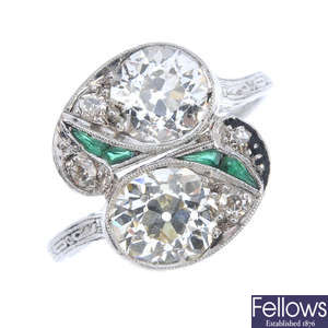 An Art Deco platinum diamond and emerald crossover ring