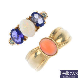 A selection of four gold gem-set rings.