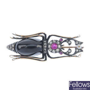 An early 20th century Russian gold diamond and gem-set stag beetle brooch.