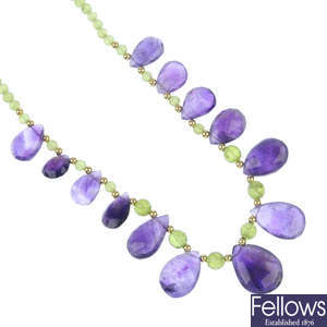 An amethyst and peridot necklace, bracelet and ear pendant set.