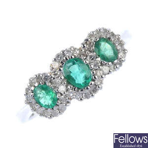 An 18ct gold emerald and diamond triple cluster ring.