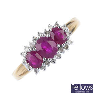 A 9ct gold ruby three-stone and diamond cluster ring.