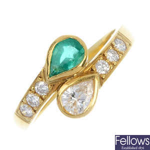 An 18ct gold diamond and emerald crossover ring.