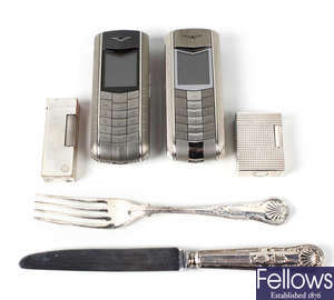 Two Vertu mobile phones, a selection of lighters, etc