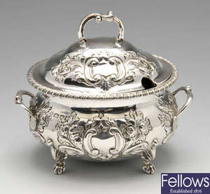 A late Victorian two handled silver sauce tureen and cover. 