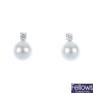 A pair of diamond and cultured pearl ear pendants.