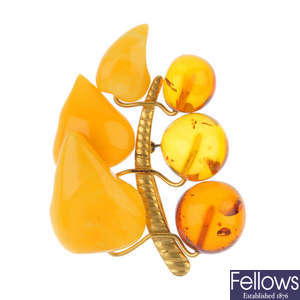 A natural amber ring, a polyburn ring and a natural and modified amber brooch.