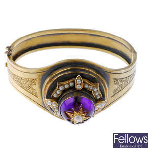 A late 19th century gold amethyst and split pearl hinged bangle.