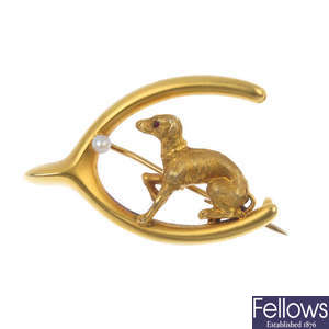 An early 20th century 15ct gold seed pearl dog and wishbone brooch.