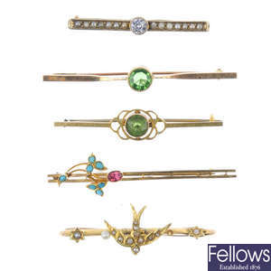A selection of six early 20th century gold gem-set bar brooches and a stickpin.