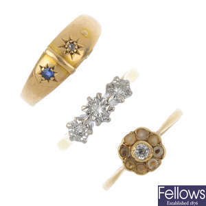 A selection of three 18ct gold diamond and gem-set rings.
