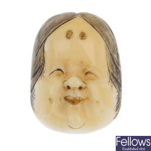 A late 19th century ivory Japanese Noh mask of Okame. 