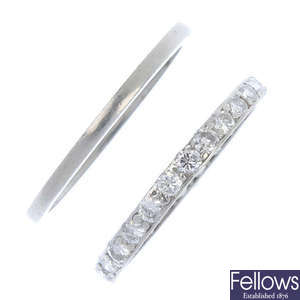 A diamond full-circle eternity ring and a plain band ring.