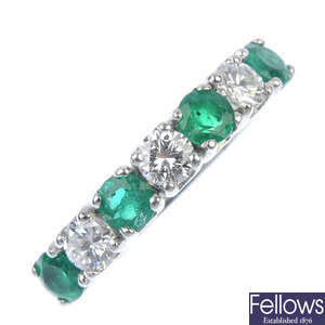 An emerald and diamond seven-stone ring.