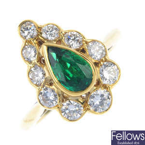 An 18ct gold emerald and diamond cluster ring. 
