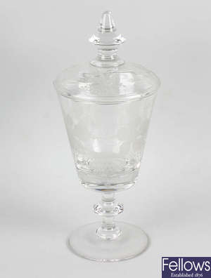 An etched glass pedestal vase and cover. 